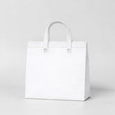 Stockk large white non-woven tote bag with reinforced handles, ideal for premium packaging and gifts.