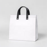 Stockk large white non-woven polypropylene tote bag with black handles, ideal for restaurants and boutiques.