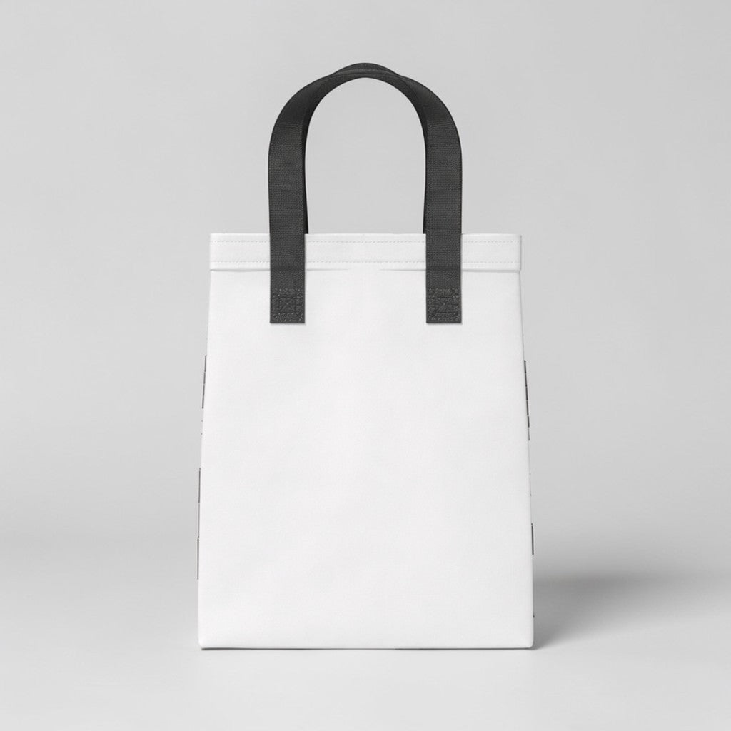 Stockk small white non-woven polypropylene tote bag with black handles, ideal for daily use and boutique packaging.