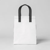 Stockk small white non-woven polypropylene tote bag with black handles, ideal for daily use and boutique packaging.