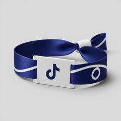 Stockka blue polyester wristband with white stripe detail and PVC tag featuring the TikTok logo.
