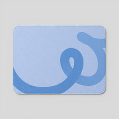 Stockka light blue mousepad with a darker blue abstract ribbon design and soft rounded corners.