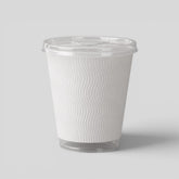 Stockka clear narrow plastic cup with textured white sleeve and flat lid, ideal for iced tea and cold brew.