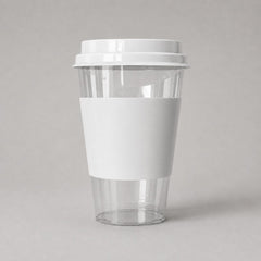 Stockka clear PET plastic cup with white cardboard sleeve and flat lid, ideal for cold drinks and takeaway.
