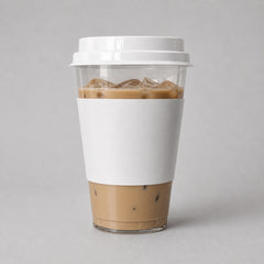 Stockka clear plastic cup with white cardboard sleeve and flat lid, filled with iced coffee.