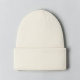 Stockka cream acrylic knit beanie with a folded cuff, perfect for winter warmth and style.