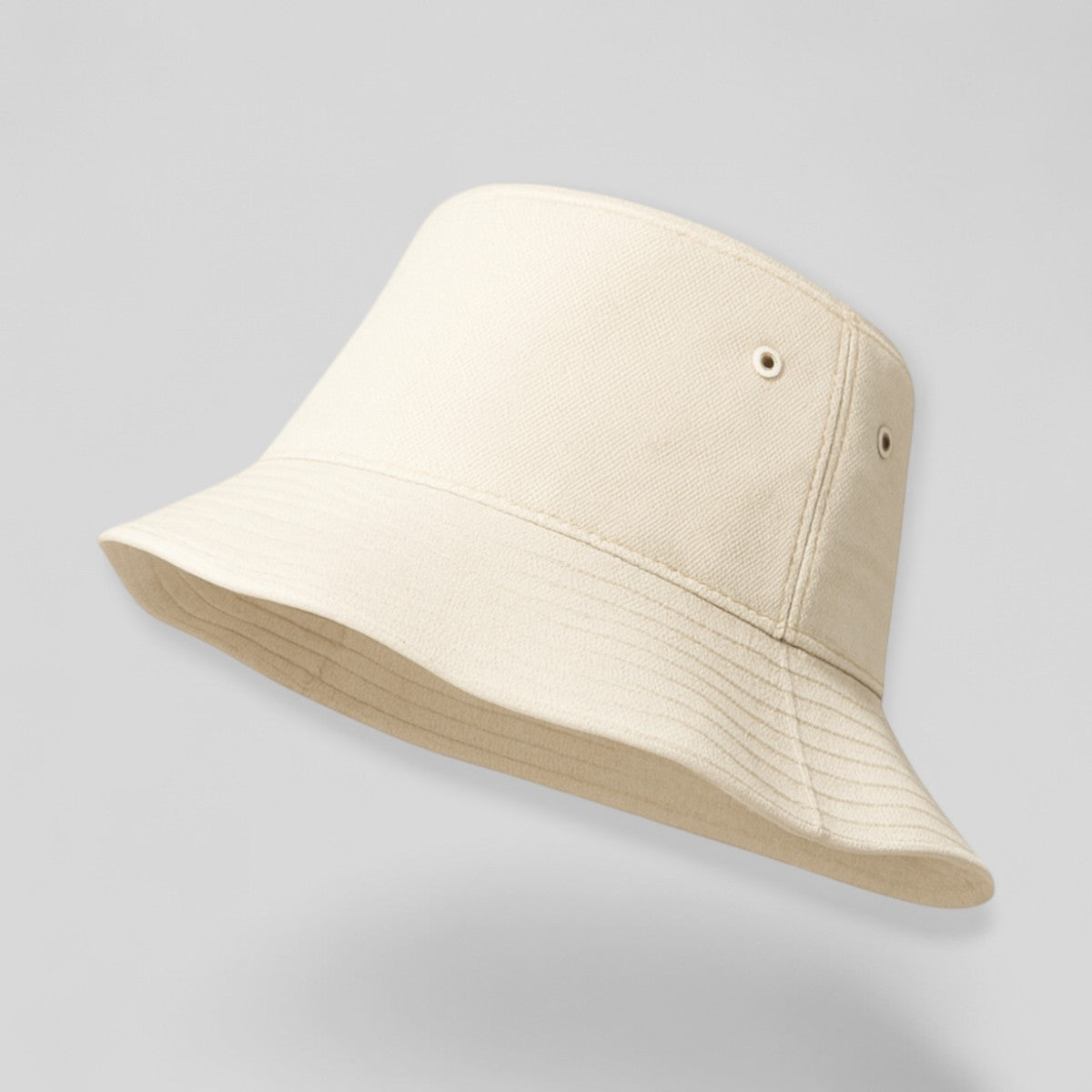 Stockka cream cotton blend bucket hat with eyelets and stitched brim. Unisex design.
