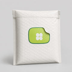 Stockka custom die-cut sticker with a green border and a white four-petal flower design on a white bubble mailer.