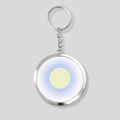 Stockka custom framed round acrylic keychain with metal chain, featuring a light yellow circle on a blue gradient background.