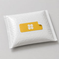 Stockka custom rectangular sticker with rounded corners and a peel tab, featuring a white four-petal logo on a yellow background.