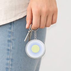 Stockka custom framed round acrylic keychain with metal chain, featuring a light green circle on a blue gradient background.