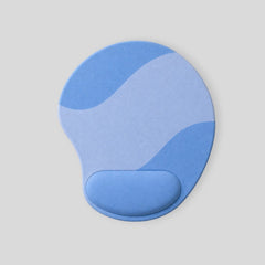 Stockka ergonomic mouse pad with wrist support in blue and light blue wave pattern. Features built-in wrist rest for comfort.