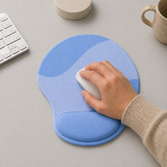 Stockka ergonomic mouse pad with wrist support in light and medium blue wave pattern. Features built-in wrist rest for comfort.