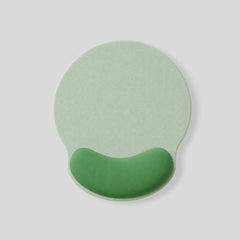 Stockka ergonomic round mouse pad in light green with a darker green wrist rest for comfortable use.
