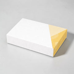 Stockka flat minimalist cardboard gift box, white with yellow geometric pattern, perfect for shirts and apparel.