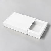 Stockka flat gift box with slide-out drawer, pink and cream, featuring a subtle flower logo. Ideal for thin items.