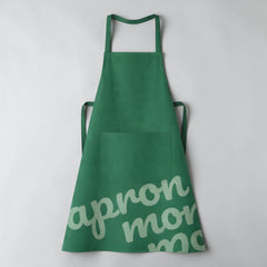 Stockka standard green polyester-cotton blend apron with front pocket and adjustable straps.