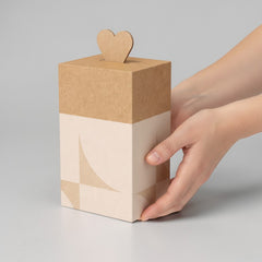 Stockka tall kraft cardboard gift box with a heart-shaped top closure and subtle geometric pattern.