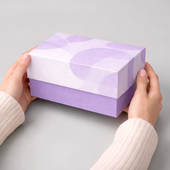 Stockka two-piece rigid cardboard gift box with separate lid and base in lavender and white abstract pattern.
