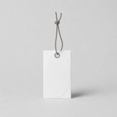 Stockka white oval embossed hang tag with reinforced eyelet and grey string