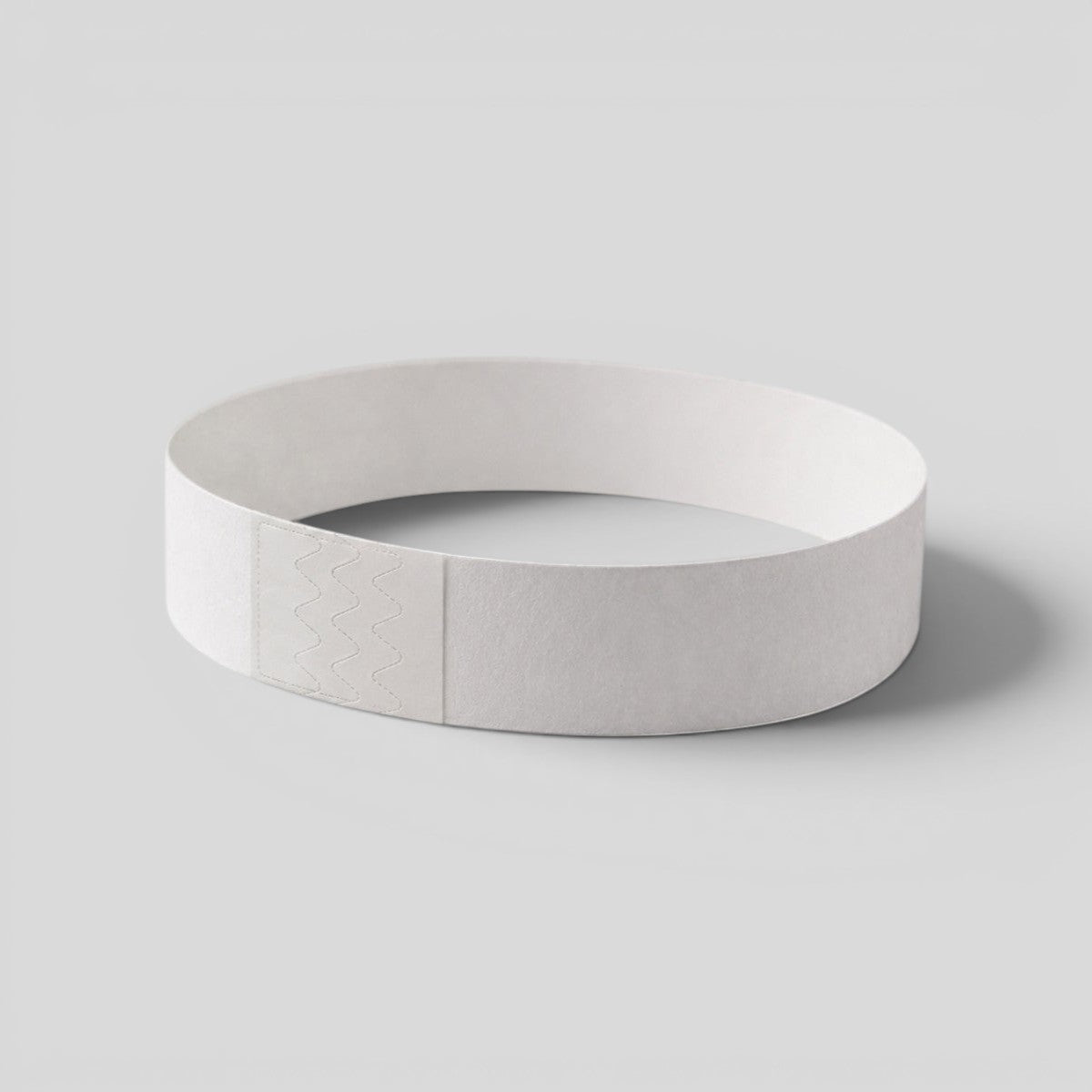 Stockka white paper wristband with smart adhesive closure for events, parties, and festivals. Water and tear resistant.
