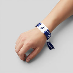 Stockka blue polyester wristband with white trim and PVC tag featuring the TikTok logo.