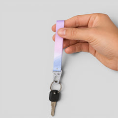 Stockka customisable polyester lanyard with metal clip, featuring a pastel purple to blue gradient, holding keys.