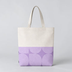Stockka natural cotton canvas tote bag with a geometric purple pattern on the bottom half. Ideal for everyday use or custom branding.