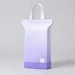 Stockka stand-up plastic bag with loop handles, ombre purple and white, ideal for gifts and retail.