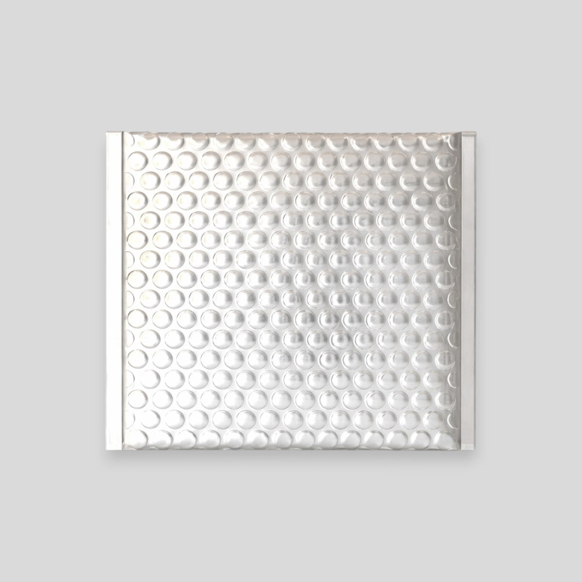Stockka silver padded bubble mailer, 4.5x7.0 cm, with secure adhesive strip for small items like jewelry.