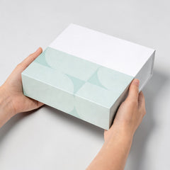 Stockka square drawer box with white lid and light blue patterned base, made of rigid cardboard with laminate.