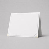 Stockka standing certificate folder, white, rigid cardboard with gold corner accents, ideal for display.
