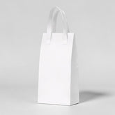 Stockka tall white kraft paper take-out bag with handles, ideal for bottles and premium deliveries.