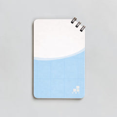 Stockka top spiral notebook with soft cover, 80 lined pages, light blue grid design.