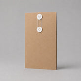 Stockka vertical brown kraft paper envelope with white string and disc closure, ideal for documents and contracts.