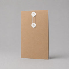 Stockka vertical brown kraft paper envelope with white string and disc closure, ideal for documents and contracts.