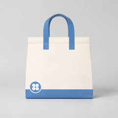 Stockka large white tote bag with blue handles and a blue base. Features a floral logo on the lower left.