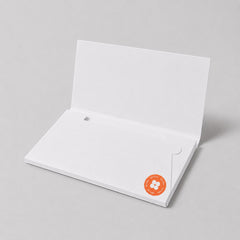 Stockka white cardboard envelope folder with an internal pocket for secure document storage and a round orange sticker.
