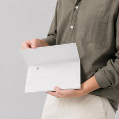 Stockka luxury white cardboard envelope with internal pocket for secure document storage.