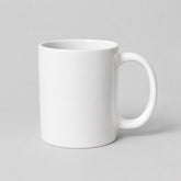 Stockka classic white ceramic mug with a comfortable handle for coffee or tea, isolated on a light grey background.