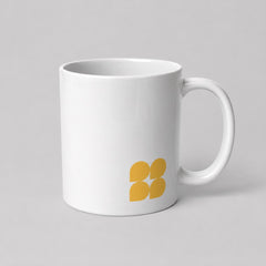 Stockka classic white ceramic mug with a yellow four-petal logo, 325ml capacity and comfortable handle.