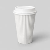 Stockka white corrugated paper coffee cup with a black plastic lid, perfect for hot beverages.