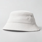Stockka white cotton bucket hat with eyelets and a textured brim. Unisex design.
