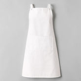 Stockka white full-length cotton-polyester blend apron with a large front pocket and adjustable shoulder straps.