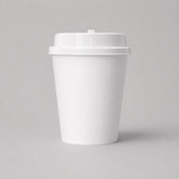 Stockka white double-walled paper coffee cup with kraft sleeve and white lid, ideal for hot beverages.