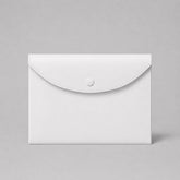 Stockka white faux leather document envelope with metal snap closure and stitched detailing. Ideal for storing certificates, documents, or invitations.