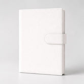 Stockka white faux leather notebook with magnetic closure, 80 lined pages, and customizable cover.