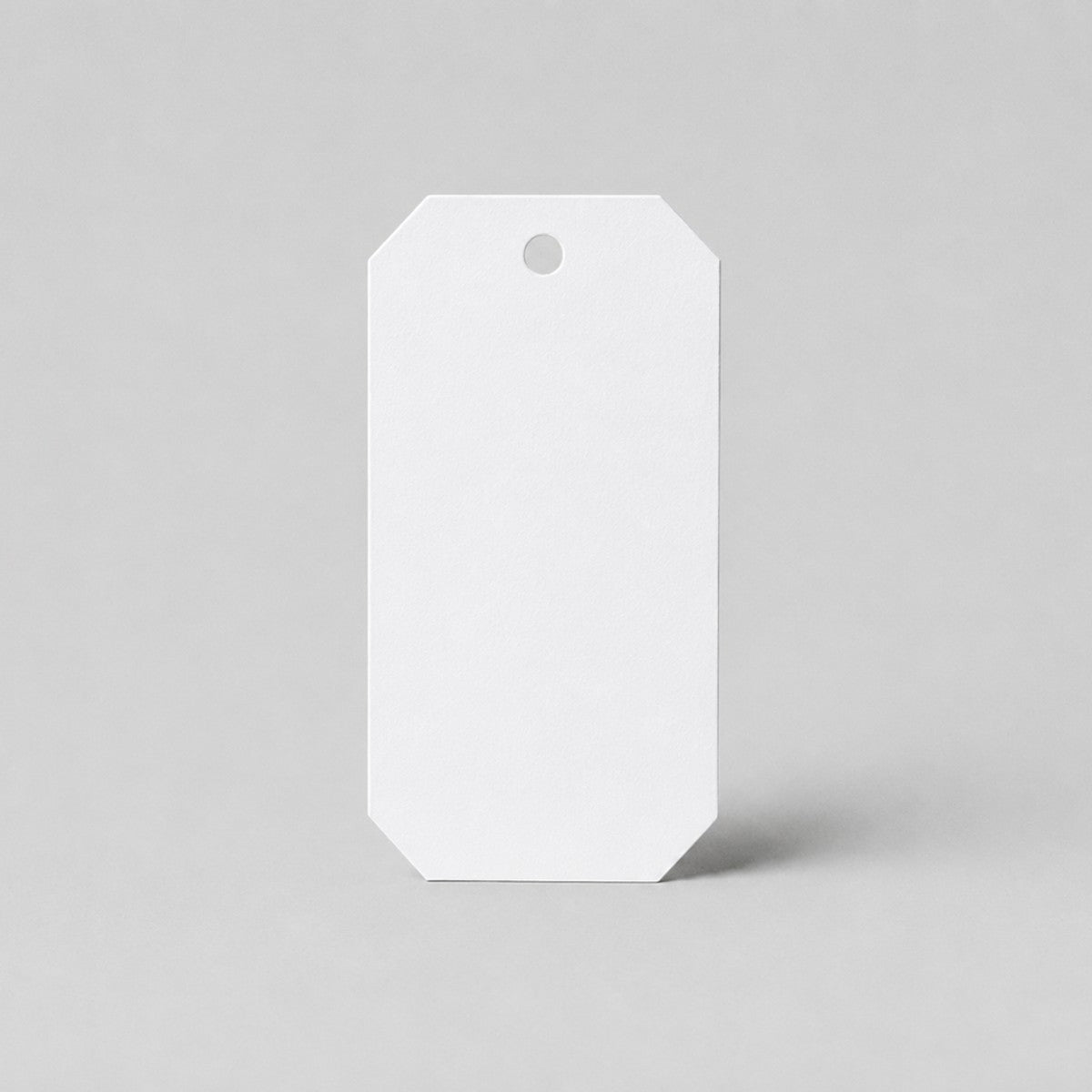 Stockka white octagonal gift tag with hole for ribbon, perfect for branding and special occasions.