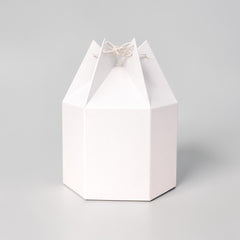 Stockka white hexagonal paper gift box with unique string closure, origami style. Perfect for festive packaging.