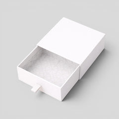 Stockka white rigid cardboard jewelry box with drawer and fabric pull tab, geometric pattern interior.